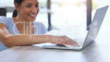 Daily care for every item. a beautiful young woman carefully cleaning a laptop at home.