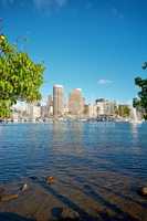 Apartments or business district beside a lagoon beach on a sunny day with a cloudy blue sky in Waikiki. A popular summer vacation tourist location in Oahu, Hawaii. Luxury resort by the ocean in USA