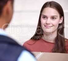 Your wish is my command. Shot of a woman accepting her delivery from the delivery man.