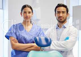 What we do fills the gap in dentistry. Portrait of a young dentist and his assistant working in their consulting room.