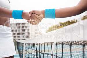 Closeup on hands of tennis players greeting on the court. Hands of a tennis player greeting an opponent. African american professional tennis players collaborate after a tennis game