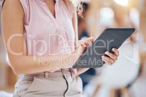 Close up of a business womans hands browsing on a digital tablet in an office. One female only using the internet online and downloading apps for planning and research in her startup