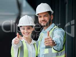 Your building plans have been approved. Cropped portrait of two young construction workers giving thumbs up while standing on a building site.