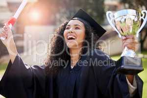 She came out tops. Shot of a young woman holding a trophy and cheering on graduation day.