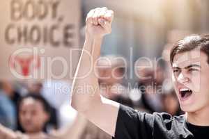 Raising our voices to bring change. a young man shouting during a protest rally.