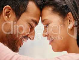 Closeup of mixed race man loving his asian wife. Headshot of hispanic couple bonding and sharing an intimate moment at home. Beautiful woman with freckles feeling in love with boyfriend