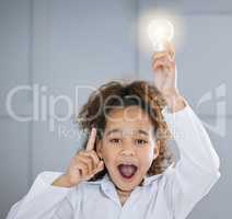 Aha. Cropped portrait of an adorable little girl wearing a labcoat and holding a lightbulb above her head.