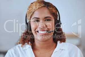 Portrait of smiling african american call center agent in office. Headshot of mixed race customer care assistant wearing headset and answering calls from clients. Hispanic salesperson calling customer