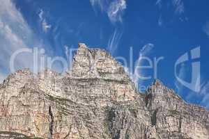 Copy space with view of Table Mountain in Cape Town South Africa against a cloudy blue sky background. Scenic landscape and beautiful panoramic of an iconic landmark and famous travel destination