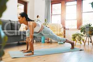 Boost your strength and immunity with regular exercise. Shot of a sporty young woman doing lunge exercises at home.