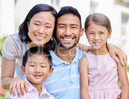 This is our family. Shot of a young family spending time together in their garden at home.