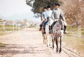 I call horses divine mirrors. Shot of three attractive young women horse riding on a farm.