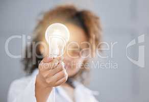 Dont let go of your ideas. an adorable little girl wearing a labcoat and holding out a lightbulb toward the camera.