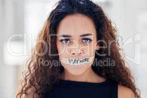 Its time to call out all forms of oppression and injustice. Portrait of a young woman with tape on her mouth that has the words stay woke written on it.