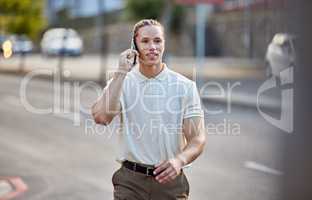 Ill be there shortly. a handsome young businessman making a call while walking through the city.