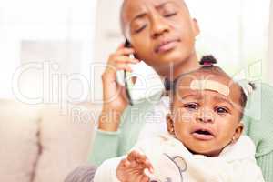 Getting her to a doctor immediately. a young mother looking stressed while making a phone call and holding her baby.