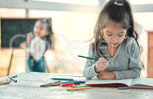 I love playing with colours. an adorable little girl doing artwork at a table.