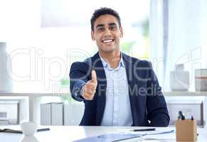 Portrait of one happy young mixed race business man gesturing thumbs up for success and agreement in an office. Confident and smiling entrepreneur expressing good luck for winning and achievement. Showing trust and support