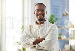 A businessman carving a lane for himself. Shot of a proud young businessman in his office.