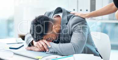 Excuse me, please wake up.... a young businessman sleeping at his desk in an office.