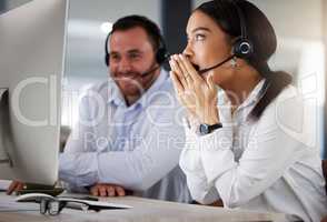 Just look at all those big sales we made today. a young call centre agent looking surprised while working on a computer in an office at night.