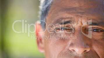 My eyes speak when words fail me. an unrecognisable man looking into the camera during a day in the park.