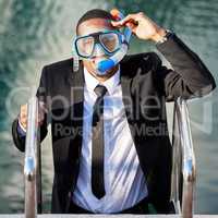 No longer drowning in debt. a businessman getting out of a pool while wearing scuba diving gear.