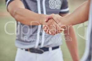 Closeup of two sportsmen shaking hands before a game. Hands pf baseball players congratulating each other after winning a match. Two unknown male competitors wishing each other goodluck on the field