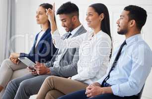 Mixed race businesswoman raising finger to ask question in interview. Diverse businesspeople team in office seminar. Group of applicants and candidates in line for job opening, vacancy, opportunity