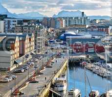 The busy city of Bodo and its surroundings by the harbor and seaside. Landscape view of a dockyard during the day in summer. Small fishing town for tourists and recreational activities for a holiday