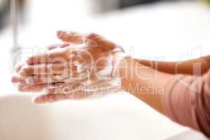 Rinse your hands thoroughly. a woman washing her hands.