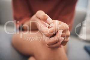 Closeup shot of a mixed race woman hands suffering mental breakdown. Young domestic violence victim afraid and suffering depression and anxiety in a safe house for abused victims of gender violence