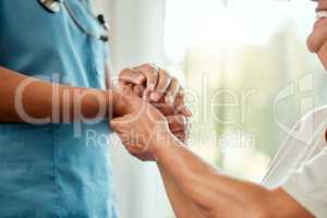 No miracle goes unseen. a nurse holding an older mans hand.