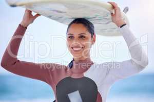 The oceans roar is music to the soul. Shot of an attractive young woman carrying a surfboard at the beach.