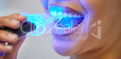 The fastest and safest approach to teeth whitening. an unrecognisable woman having her teeth whitened at the dentist.