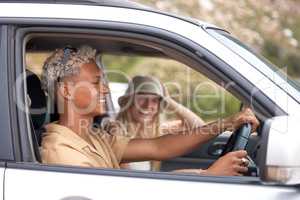 One beautiful blonde caucasian woman and her hispanic boyfriend enjoying a road trip. An attractive young female and mixed race male taking a drive. Enjoying the open road