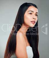 Long hair and big dreams. Studio shot of a beautiful young woman with long brown hair.