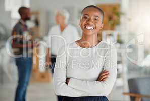 Portrait of a happy African american businesswoman standing with her arms crossed at work. One confident black female manager standing in an office at work. One content expert business professional at work