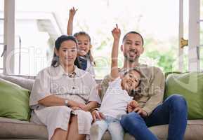 This is where we find our happiness. Shot of a young family spending time together at home.