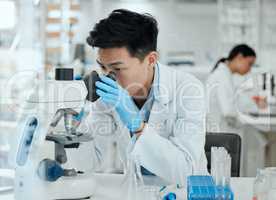 Finally my experiment results have arrived. Shot of a young male scientist using a microscope.