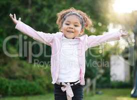 Look at me fly. Portrait of an adorable little girl having fun outdoors.