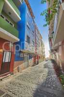 Historical city street view of residential houses in small and narrow alley or road in tropical Santa Cruz, La Palma, Spain. Village view of vibrant buildings in popular tourism destinations overseas