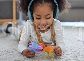 Stimulation comes in many forms. a little girl playing with toys while listening to music in a physiologists office.