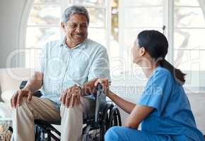 You look good today. a handsome senior man and his female nurse in the old age home.