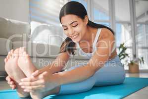 Your fitness journey is just as important as the outcome. a sporty young woman stretching while exercising at home.