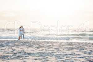 Belonging and caring anchors our sense of place in the universe. a young couple spending time together at the beach.