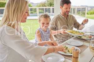 Spending time together is what matters. a family enjoying sunday lunch together on their patio.