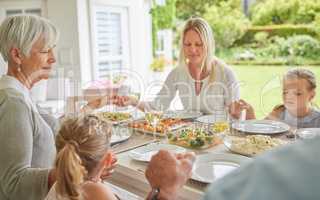 Ready to enjoy a delicious meal. a family enjoying sunday lunch together on their patio.