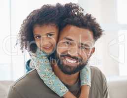 A happy family is but an earlier heave. a father and his little daughter relaxing together at home.