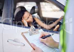 There are consequences if you disobey the law. Closeup shot of a traffic officer issuing a woman with a ticket.